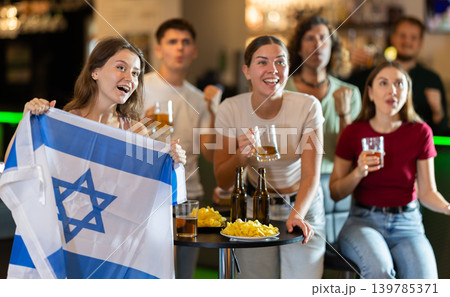Group of fans in bar with Israeli flag 139785371