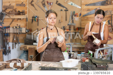 Girl is busy in carpentry workshop Girl is busy in carpentry workshop 139785610