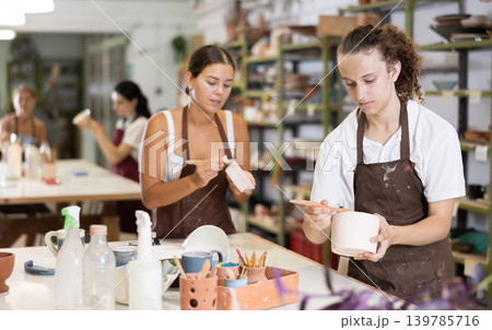 Guy performs polishing of ceramic product Guy performs polishing of ceramic product 139785716