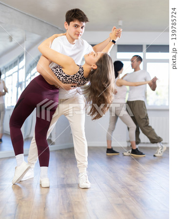 Young couple practicing passionate samba in dance class Young couple practicing passionate samba in dance class 139785724