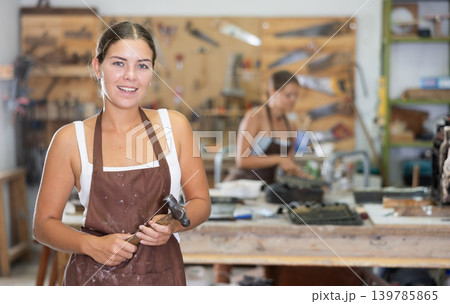 Young girl posing in taller workshop Young girl posing in taller workshop 139785865