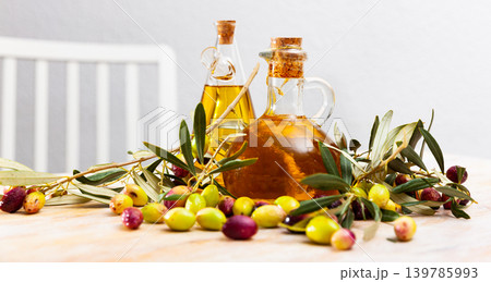 Olive oil in bottles on wooden table 139785993