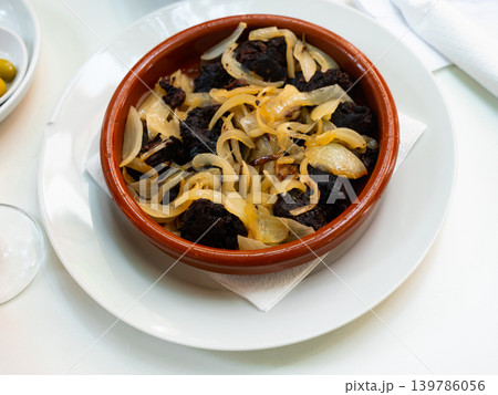 Slices of fried morcilla served with caramelized onions Slices of fried morcilla served with caramelized onions 139786056