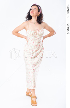 Portrait of an attractive slim woman in long summer dress on white background 139786089