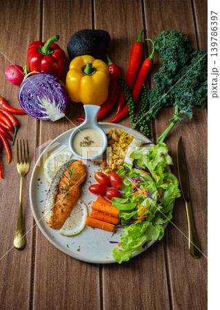 Grilled salmon fish fillet and fresh vegetable salad. Healthy food. Top view Grilled salmon fish fillet and fresh vegetable salad. Healthy food. Top view 139786397