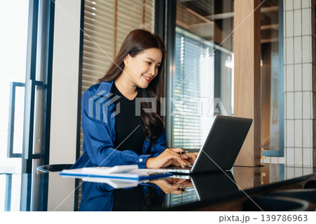 Business woman using tablet and laptop for doing math finance on an office desk, tax, report, accounting, statistics, and analytical research concept in office Business woman using tablet and laptop for doing math finance on an office desk, tax, report, accounting, statistics, and analytical research concept in office 139786963