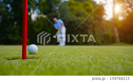 Golfers are putting golf in the evening golf course golf backglound. Golfers are putting golf in the evening golf course golf backglound. 139788215