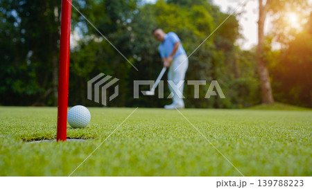 Golfers are putting golf in the evening golf course golf backglound. 139788223