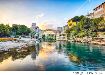 Amazing Skyline of Mostar with the Mostar Bridge, houses and minarets, at sunset. Amazing Skyline of Mostar with the Mostar Bridge, houses and minarets, at sunset. 139789167
