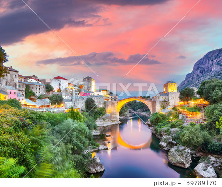 Amazing Skyline of Mostar with the Mostar Bridge, houses and minarets, at sunset. Amazing Skyline of Mostar with the Mostar Bridge, houses and minarets, at sunset. 139789170