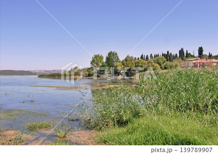 Golyazi Lakeside Village Bursa,Turkiye. Serene view of Golyazi on Uluabat Lake, Bursa, Turkey. Golyazi Lakeside Village Bursa,Turkiye. Serene view of Golyazi on Uluabat Lake, Bursa, Turkey. 139789907