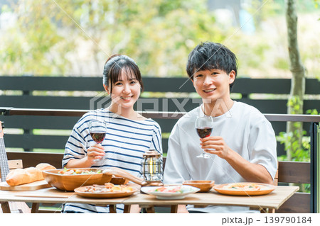 ウッドデッキ,テラス席,バルコニー席で食事するカップル,夫婦（グランピング・ベランピング） 139790184