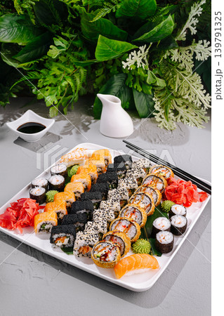 Sushi platter with various rolls and sides served on a white plate Sushi platter with various rolls and sides served on a white plate 139791325