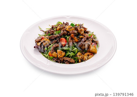 Beef salad with vegetables and herbs served on a white plate Beef salad with vegetables and herbs served on a white plate 139791346