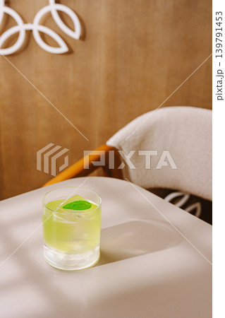 Mixing a fresh drink on a table in a cozy indoor setting during the afternoon Mixing a fresh drink on a table in a cozy indoor setting during the afternoon 139791453