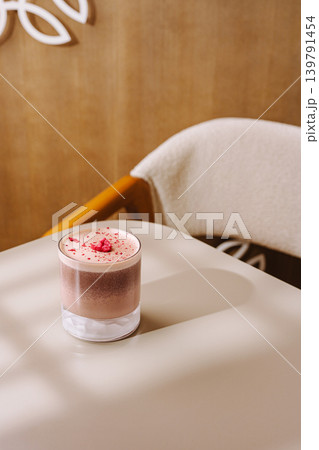 Delicious drink served in a glass on a simple table at a cozy cafe Delicious drink served in a glass on a simple table at a cozy cafe 139791454