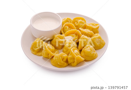 Dumplings served with sauce on a plate during dinner time Dumplings served with sauce on a plate during dinner time 139791457
