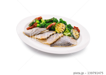 Fresh fish served with green vegetables on a white plate Fresh fish served with green vegetables on a white plate 139791475