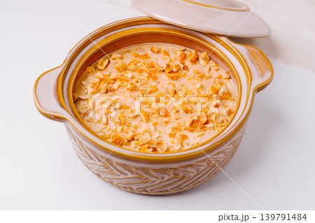 Delicious dessert in a bowl with nuts on top from a cozy kitchen Delicious dessert in a bowl with nuts on top from a cozy kitchen 139791484