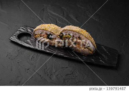 Sushi rolls presented on a black wooden tray ready for serving 139791487
