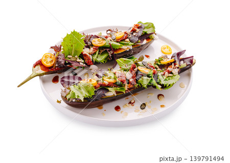 Salad served on eggplant with vegetables and crunchy toppings on a plate Salad served on eggplant with vegetables and crunchy toppings on a plate 139791494