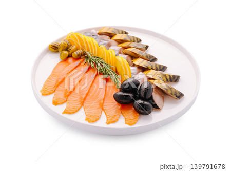 Seafood platter with smoked fish and olives served on a round white plate 139791678