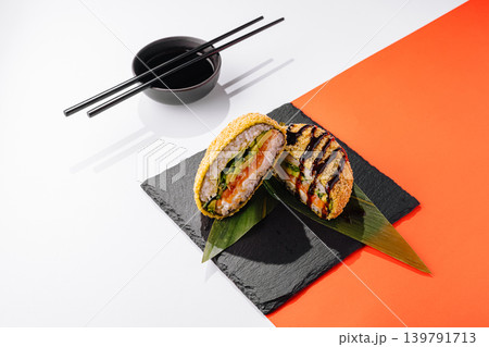 Sushi dish on slate plate with chopsticks and dipping sauce on white background 139791713