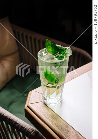 Fresh drink with mint leaves on table in cozy cafe during daytime Fresh drink with mint leaves on table in cozy cafe during daytime 139791752