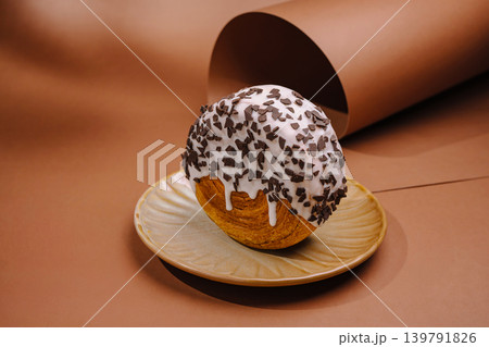 Delicious dessert on a plate with brown background and chocolate sprinkles Delicious dessert on a plate with brown background and chocolate sprinkles 139791826