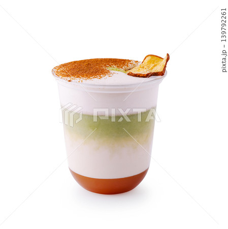 Layered matcha latte with caramel and cinnamon topping 139792261