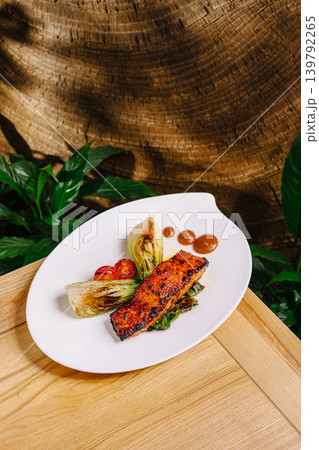Fresh grilled salmon with vegetables served on a white plate 139792265