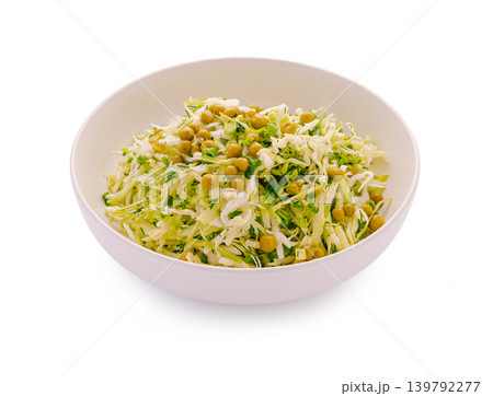 Cabbage salad with peas served in a white bowl on a plain background 139792277