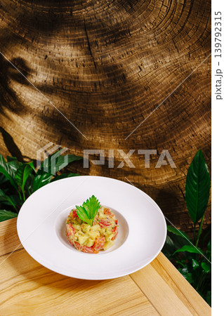 Gourmet salmon tartare with avocado on wooden background Gourmet salmon tartare with avocado on wooden background 139792315