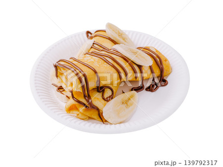 Banana and chocolate crepes served on a plate with no background Banana and chocolate crepes served on a plate with no background 139792317