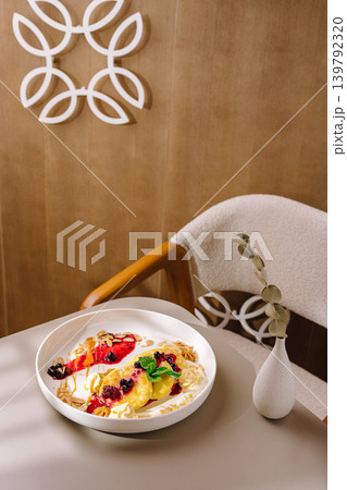 Cottage cheese pancakes syrniki with berry sauce in cafe Cottage cheese pancakes syrniki with berry sauce in cafe 139792320