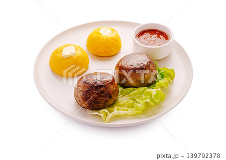 Fried meat cutlets with mamaliga and red sauce on a white plate Fried meat cutlets with mamaliga and red sauce on a white plate 139792378