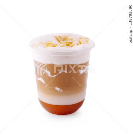 Delicious layered drink with cream and sweet topping and almond flakes enjoyed in a cafe setting Delicious layered drink with cream and sweet topping and almond flakes enjoyed in a cafe setting 139792390