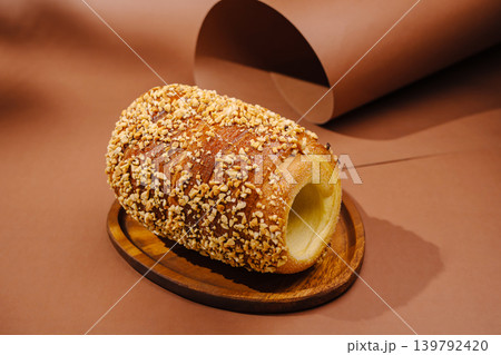 Freshly baked pastry with nuts on a wooden plate in a simple setting Freshly baked pastry with nuts on a wooden plate in a simple setting 139792420