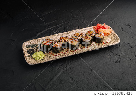 Sushi rolls served on a plate with wasabi and pickled ginger at dinner time 139792429