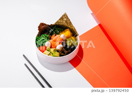 Delicious bowl of fresh sushi ingredients in white bowl on bright background Delicious bowl of fresh sushi ingredients in white bowl on bright background 139792450