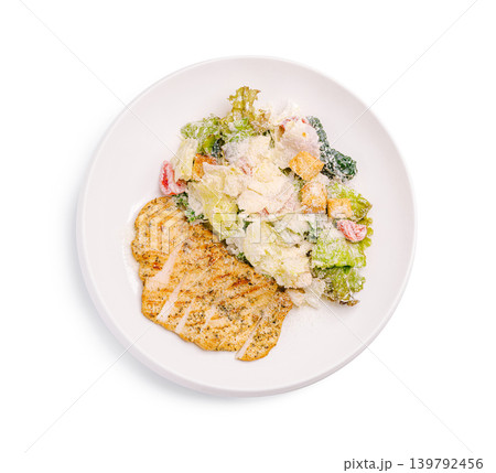 Classic Caesar salad with grilled chicken fillet steak served on a plate with dressing 139792456