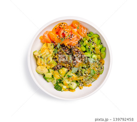 Healthy bowl with salmon, avocado, edamame, and quinoa served in a white dish 139792458