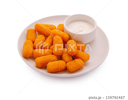 Fried cheese sticks with dipping sauce isolated on a white plate in a simple setting Fried cheese sticks with dipping sauce isolated on a white plate in a simple setting 139792487