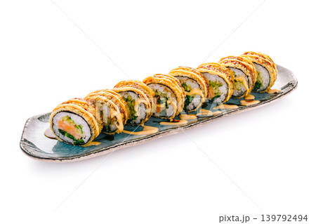Sushi rolls served on a platter with sauce in a restaurant setting Sushi rolls served on a platter with sauce in a restaurant setting 139792494