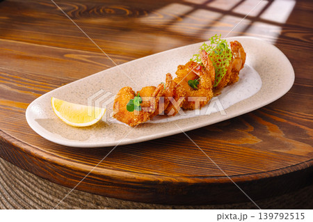 Shrimp dish served with lemon on a white plate at a restaurant Shrimp dish served with lemon on a white plate at a restaurant 139792515
