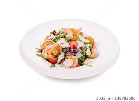 Shrimp salad with greens and tomatoes served on a white plate 139792606