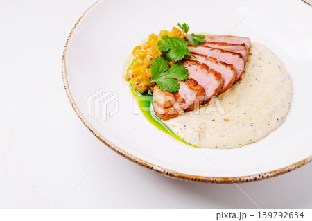 Duck breast served with sauce and corn salsa on a white plate Duck breast served with sauce and corn salsa on a white plate 139792634