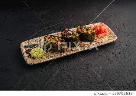 Gunkan maki sushi with eel and ginger on dark stone Gunkan maki sushi with eel and ginger on dark stone 139792638
