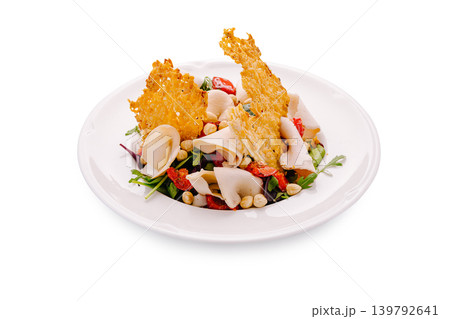 Fresh salad with chicken, nuts, and cheese on a white plate 139792641