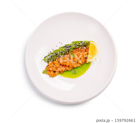Salmon tartare with avocado and lemon on a white plate with fresh ingredients and sauce Salmon tartare with avocado and lemon on a white plate with fresh ingredients and sauce 139792661
